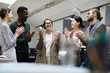 © Seventyfour - Waist up portrait of multi-ethnic group of business people applauding cheerfully while celebrating promotion during coffee break in office, copy space