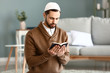 © Pixel-Shot - Young Muslim man praying indoors