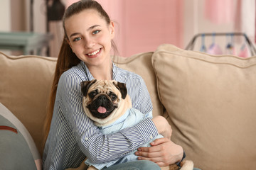 Canvas Print - Teenage girl with cute pug dog at home