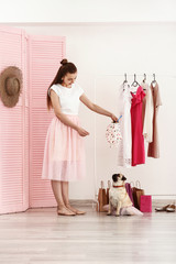 Poster - Teenage girl with cute pug dog in dressing room