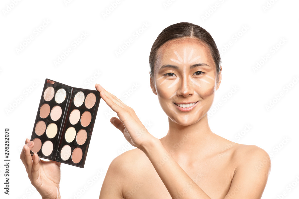 Asian woman with cosmetics for contouring makeup on white background