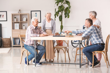 Wall Mural - Elderly people playing chess in nursing home