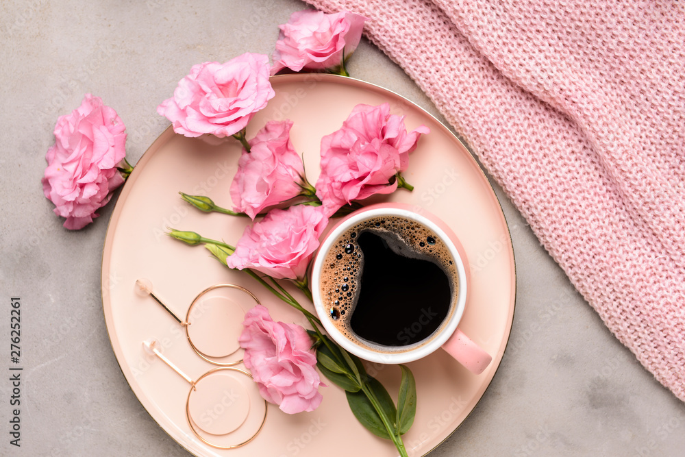 Composition with beautiful fresh flowers and cup of coffee on grey background
