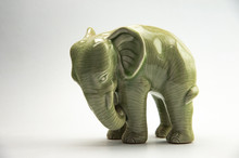 Charming Green Porcelain Elephant Isolated On White Background.