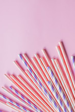 Row Of Drinking Straws With Stripe And Polka Dot Design Border On Pink Background.prohibition Of The Use Of Plastic.Minimalism Concept. Pop Art Style.Paper Straws Used For Drinking Water Or Soft