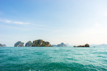 Seascape Of Tropical Islands With Cliffs And Mountains Covered By Greenery In Azure Sea  Water Under Blue Sky In Sunny Day In Thailand
