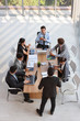 © feeling lucky - top view of caucasian lecturer giving public presentation with company business graph result on white board in meeting room and multiethnic business people are paying attention