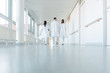 Leinwandbild Motiv Three doctors walking down a corridor in hospital