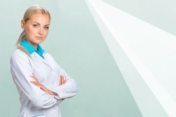 Wall Mural - Portrait of happy smiling confident glad beautiful with blonde hair female family doctor wearing white coat