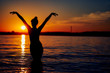 © Aleksandr - girl in the water in the setting sun. Beach holiday concept. silhouette image.