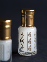 perfume in a mini bottle on the black background