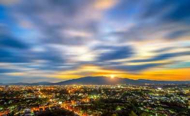 Chiang Mai cityscape at twilight from a high angle with light of building and Doi Suthep as a background.