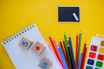 Back to school colorfull flatlay. Pencils notepad numbs a b c alphabet waterolors.