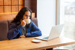 © khosrork - Portrait of satisfied handsome intelligence young adult man freelancer in casual style sitting in cafe with laptop, drinking cup of coffee and smile, bussinessman in office. Indoor, lifestyle concept