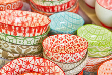 Group Of Ceramic Bowls In The Store. Plates With Different Colorful Patterns.
