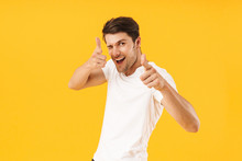 Photo Of Positive Man In Basic T-shirt Gesturing Index Fingers On Camera Meaning Hey You