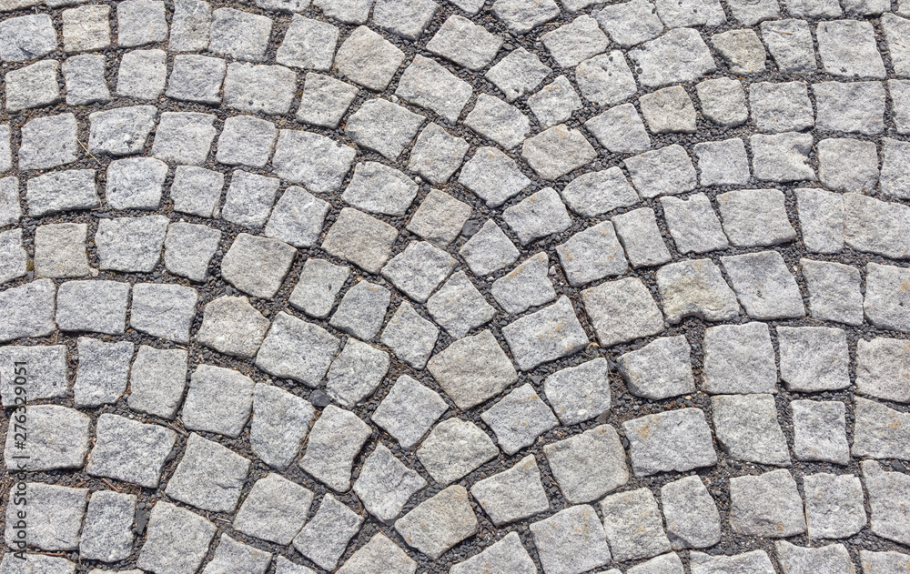 Old road paved with granite stones. - obrazy, fototapety, plakaty 