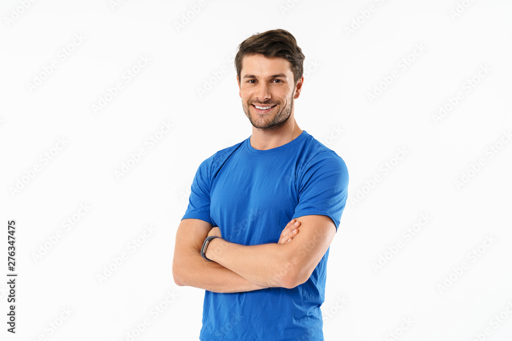 Attractive young fit sportsman wearing t-shirt standing - obrazy, fototapety, plakaty 