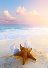 Sticker - summer tropical beach background; starfish, sand and water edge;