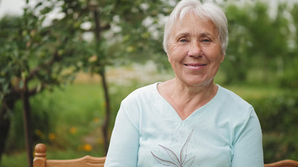 Portrait of an old woman on nature