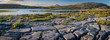 A panorama of the stunning and mars like landscape that is The Burren National Park, County Clare, Ireland at dusk.