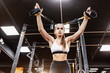 © Rithor - Bottom view - a tired but strong young woman coach is engaged in gym and committed to goal. The concept of women's selflessness and will. Copyspace