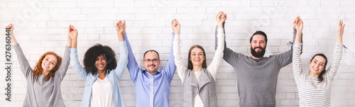 Fotomural Success of togetherness. Group of millennials holding hands