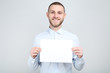 © 5second - Young man with white blank board on grey background