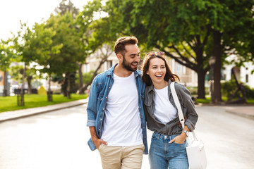 beautiful young couple in love walking outdoors at the city street