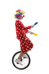 Canvas Print - Juggler clown riding a unicycle and juggling