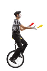 Canvas Print - Mime juggler riding a unicycle and throwing plastic clubs