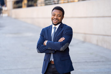 Half length portrait of an attractive stylish and successful businessman outside city street