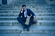 © SB Arts Media - Sad business man suffering from depression in total despair hopeless and frustrated in city stairs