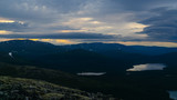 Fototapeta Góry - Rays of the setting sun over the mountain valley Khibiny