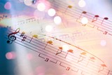 Sheets with music notes and abstract light bokeh