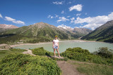 Fototapeta Do pokoju - tourist girl on a mountain lake, Almaty