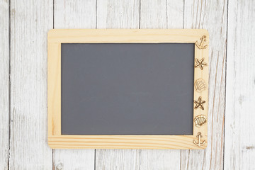 Wall Mural - Blank chalkboard with nautical objects on weathered whitewash textured wood background