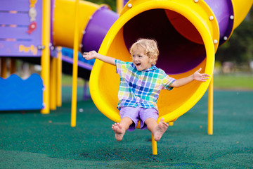 Child on playground. Kids play outdoor.