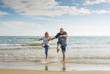 © SB Arts Media - Senior couple in love walking on the beach having fun in a sunny day