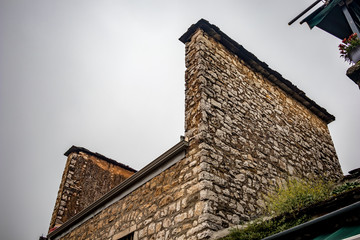 Strange roof with two side stone walls of old Greek residential building, Ioannina downtown, Greece. Moody foggy spring morning, no people