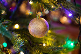 Fototapeta Tęcza - Golden decoration globe on christmas tree close up