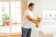 © Krakenimages.com - Middle age man holding grocieries bag full of vegetables at home