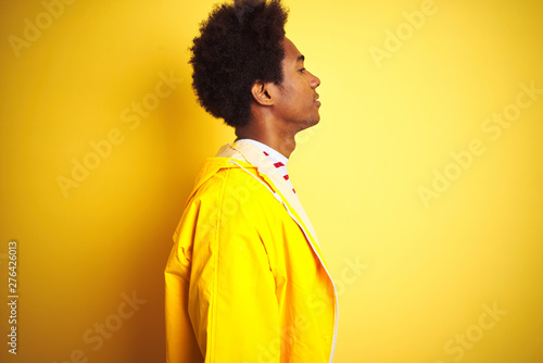 African American Man With Afro Hair Wearing Rain Coat Standing