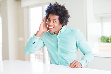 Sticker - African American business man wearing elegant shirt smiling with hand over ear listening an hearing to rumor or gossip. Deafness concept.