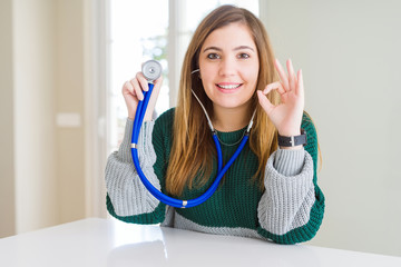 Sticker - Beautiful young woman checking health with stethoscope doing ok sign with fingers, excellent symbol