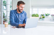 © Krakenimages.com - Handsome business man working using computer laptop and smiling