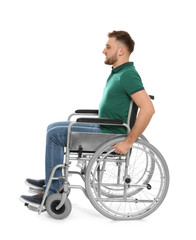 Wall Mural - Handsome young man in wheelchair isolated on white