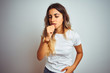 © Krakenimages.com - Young beautiful woman wearing casual white t-shirt over isolated background feeling unwell and coughing as symptom for cold or bronchitis. Healthcare concept.