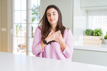 Poster - Beautiful young woman wearing pink sweater smiling with hands on chest with closed eyes and grateful gesture on face. Health concept.