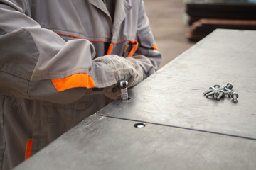 Wall Mural - Workers collect the scene. Work tool assembly designs. Hammer, screwdriver and nuts. Hand work. Project implementation.